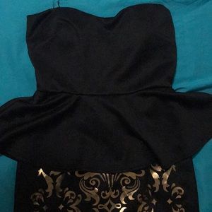 Strapless black mini dress with gold accents
